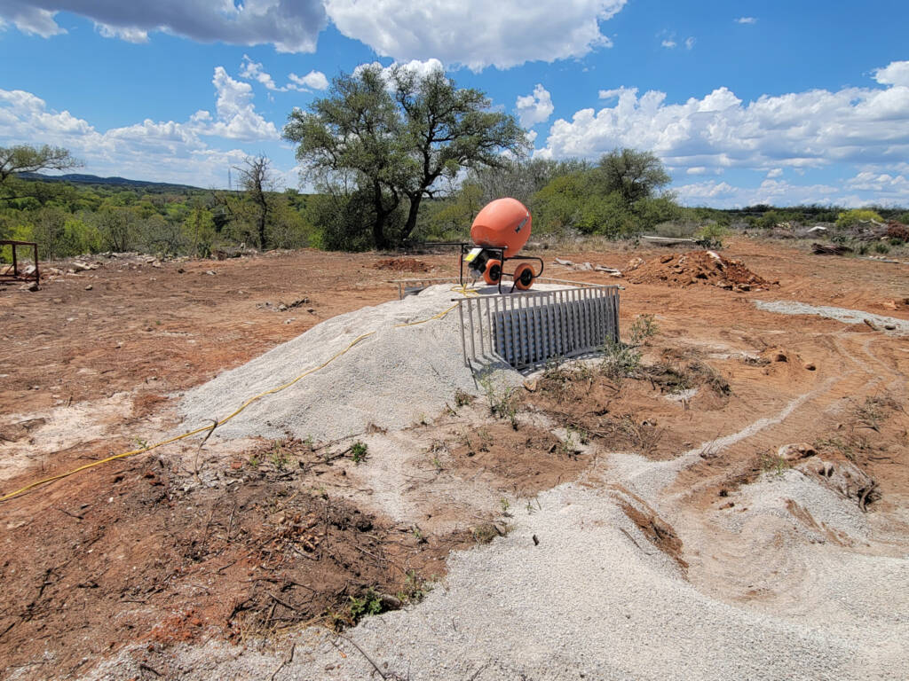 Elevated cement mixer to make it easy to fill skidsteer bucket
